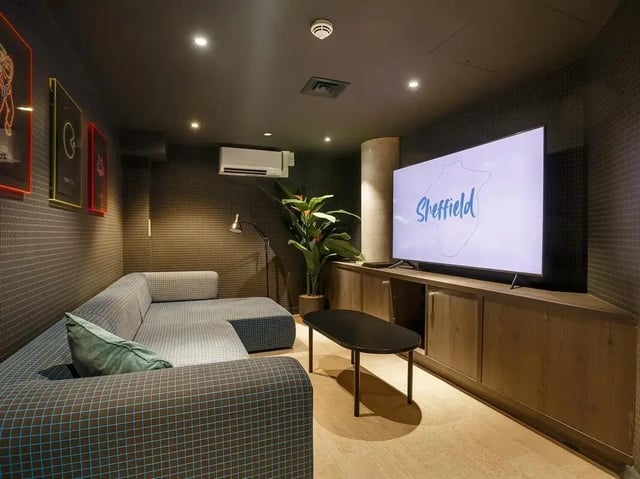 Lounge area with sectional sofa and television living room at COSMOS in Sheffield Student Accommodation