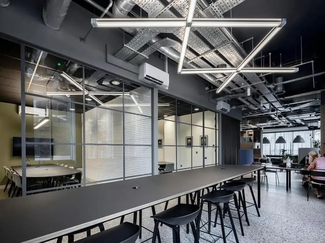 Long table with stools study areas and chairs communal area at COSMOS in Sheffield Student Accommodation