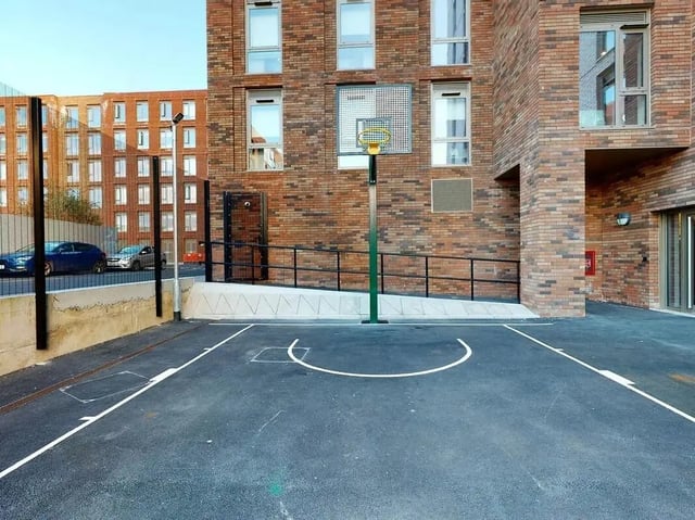 Basketball hoop on paved court exterior at COSMOS in Sheffield Student Accommodation