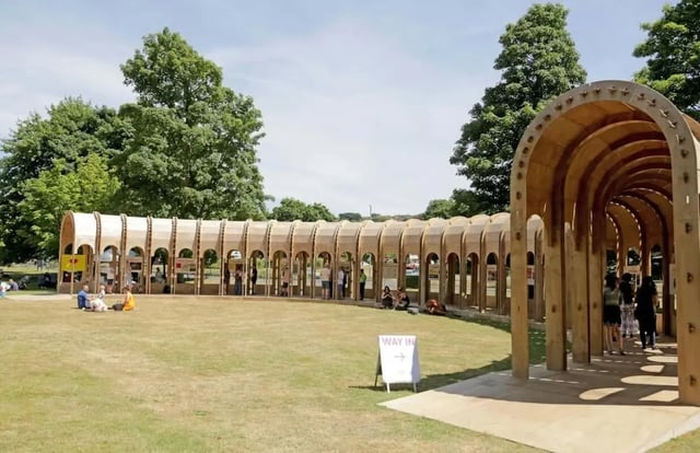 Arched structure people on lawn Way In sign exterior at Moulsecoomb Place in Brighton Student Accommodation