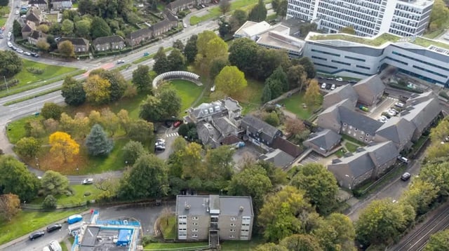 Apartment buildings among trees and greenery exterior at Moulsecoomb Place in Brighton Student Accommodation
