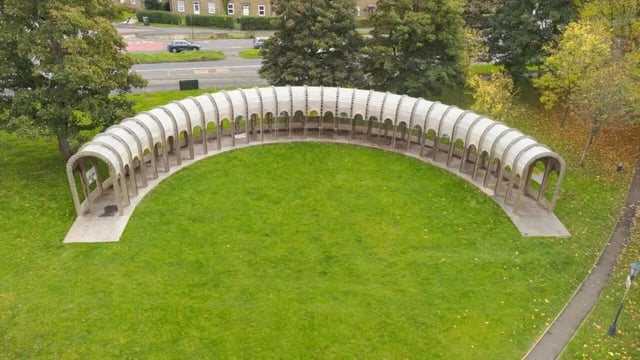 Curved arched shelter on green lawn exterior at Moulsecoomb Place in Brighton Student Accommodation