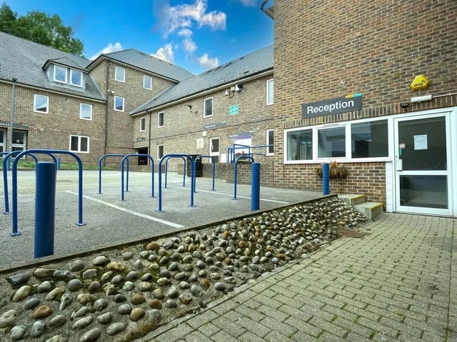 Brick building reception and bike racks exterior at Moulsecoomb Place in Brighton Student Accommodation