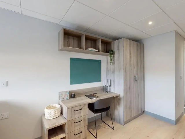 Desk whiteboard shelves and wardrobe study area at Crown Place Swansea in Swansea Student Accommodation