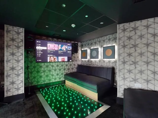 Sofa screen with lights and artwork living room at Crown Place Swansea in Swansea Student Accommodation