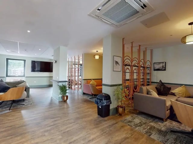 Sofas and seating area with decorative screen Living room at Crown Place Swansea in Swansea Student Accommodation