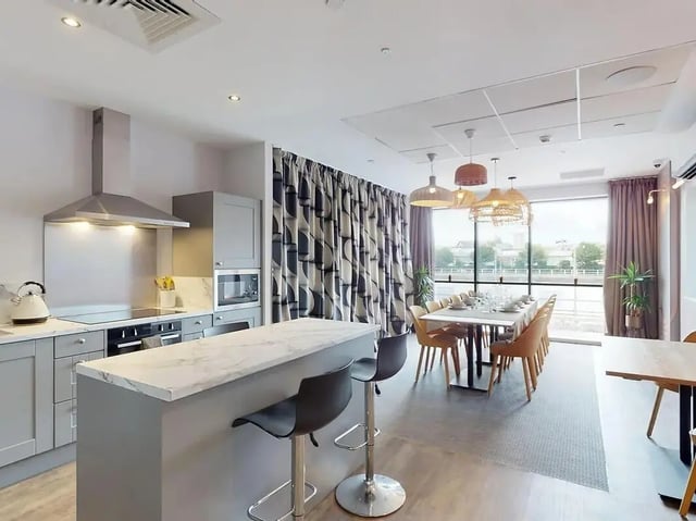 Kitchen island breakfast bar dining table and chairs. at Crown Place Swansea in Swansea Student Accommodation