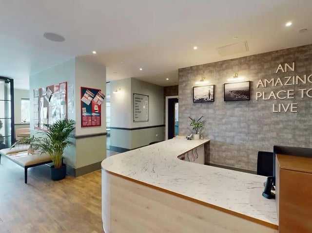 Reception desk plant bulletin board lobby area at Crown Place Swansea in Swansea Student Accommodation