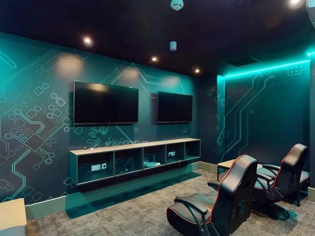 Two TVs gaming chairs entertainment unit playing area at Crown Place Swansea in Swansea Student Accommodation