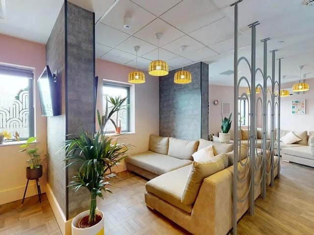 Sectional sofas plants and pendant lights common area at Crown Place Swansea in Swansea Student Accommodation