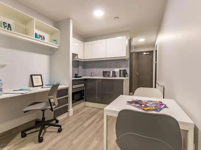 Desk chair kitchen counter table and chairs studio apartment at ViBe Student Living in Kingston Upon Thames Student Accommodation