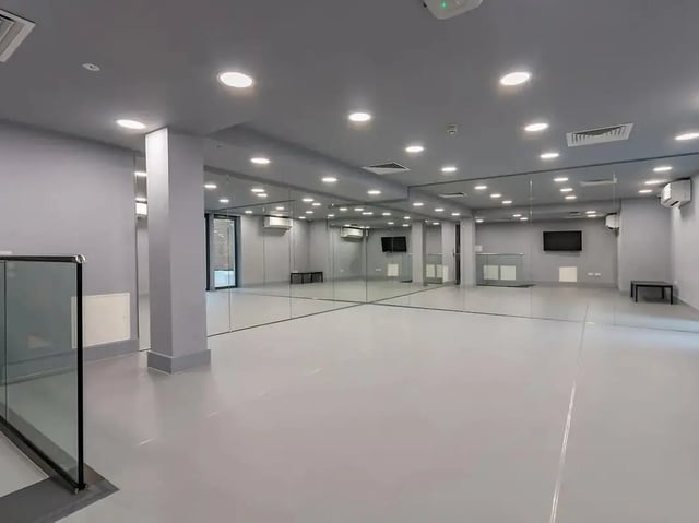 Mirrored walls bright lights and benches playing area at ViBe Student Living in Kingston Upon Thames Student Accommodation