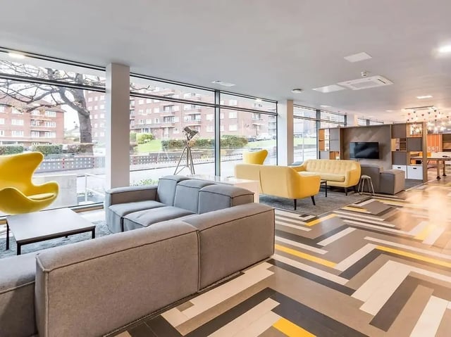 Modern lounge with grey sofas yellow chairs living room at ViBe Student Living in Kingston Upon Thames Student Accommodation