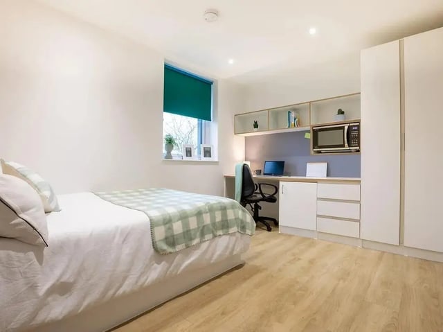 Bed desk microwave storage wardrobe bedroom at Elmstead Place in Colchester Student Accommodation