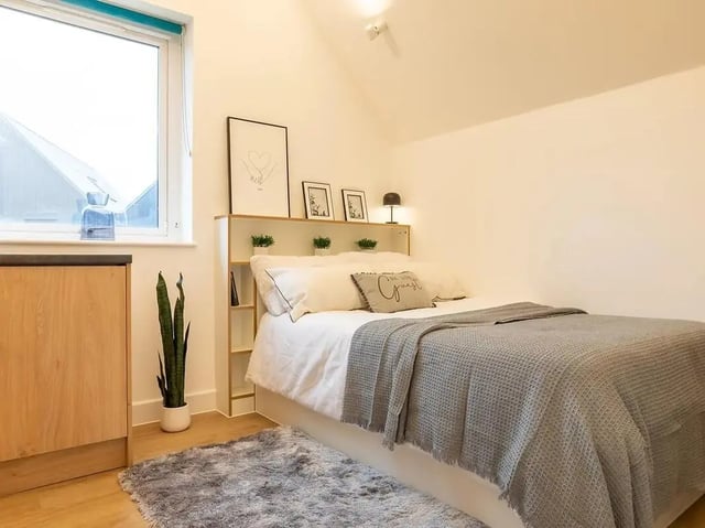 Bed with bedside shelves and fluffy rug bedroom at Elmstead Place in Colchester Student Accommodation