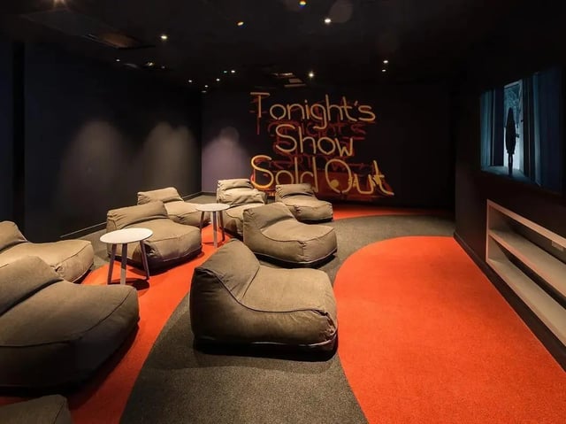 Beanbag chairs and small tables in a lounge room. at Grand Felda House in Wembley Student Accommodation