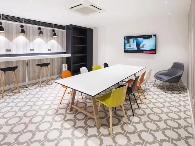 Table chairs TV shelf and bar seating communal area at Grand Felda House in Wembley Student Accommodation