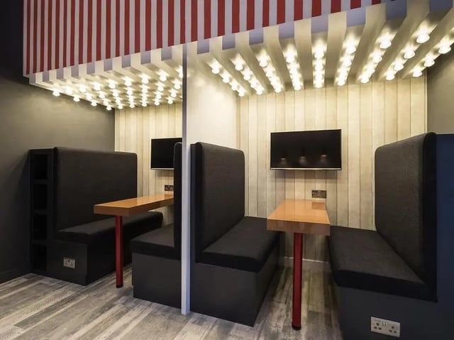 Booths with tables and televisions study area at Grand Felda House in Wembley Student Accommodation