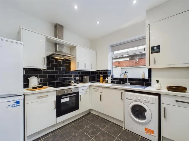 White kitchen appliances with black tiled backsplash kitchen at 4 Bedroom House at 102, Leopold Road in Liverpool Student Accommodation