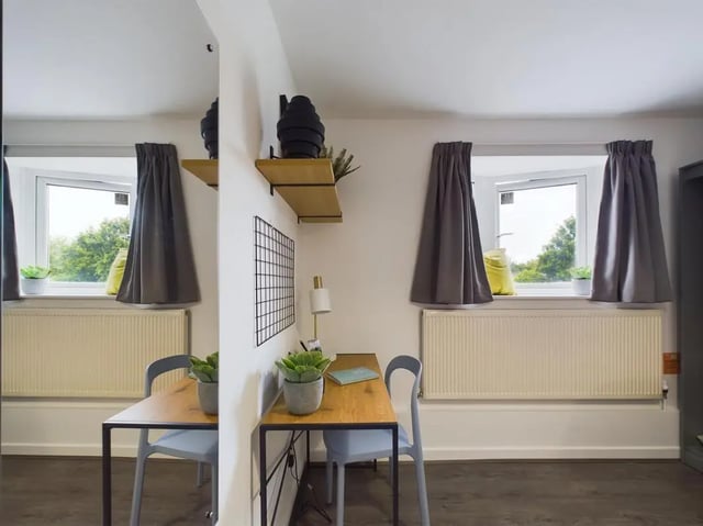 Two desks plants lamps windows and curtains study area at 6 Bedroom House at 2, Flat 2, Windsor House, Clint Road West in Liverpool Student Accommodation