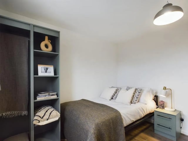 Bed pillows blanket shelves and bedside table bedroom at 6 Bedroom House at 2, Flat 2, Windsor House, Clint Road West in Liverpool Student Accommodation