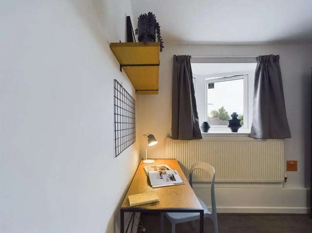 Desk lamp chair shelves window study area at 6 Bedroom House at 2, Flat 2, Windsor House, Clint Road West in Liverpool Student Accommodation