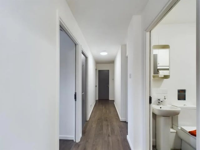 Hallway with doors and visible sink and toilet Bathroom at 6 Bedroom House at 2, Flat 2, Windsor House, Clint Road West in Liverpool Student Accommodation