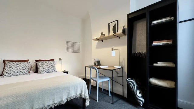 Bed desk bookshelf and pillows bedroom at 4 Bedroom House at 126, Empress Road in Liverpool Student Accommodation