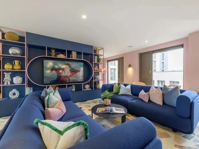 Blue sectional sofa, TV, shelves, coffee table Living Room at Yugo Bottleworks in Cork Student Accommodation