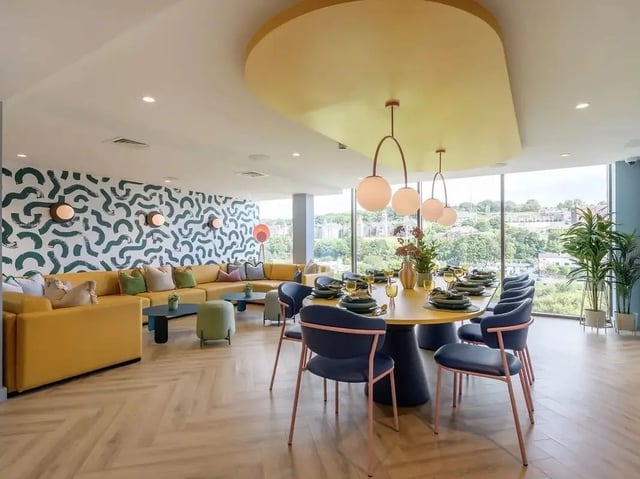 Yellow sofa round dining table with chairs communal area at Yugo Bottleworks in Cork Student Accommodation