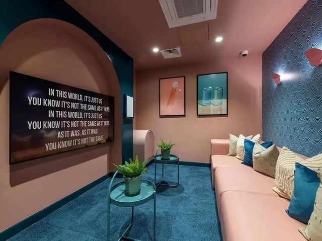 Pink couch with pillows screen art lounge area at Yugo Bottleworks in Cork Student Accommodation