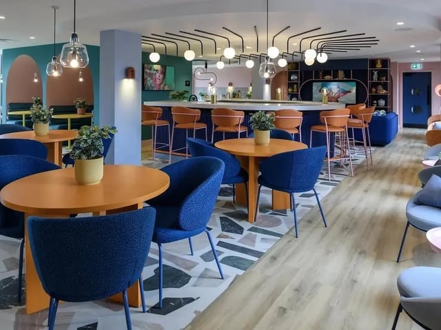 Orange tables blue chairs bar area communal area at Yugo Bottleworks in Cork Student Accommodation