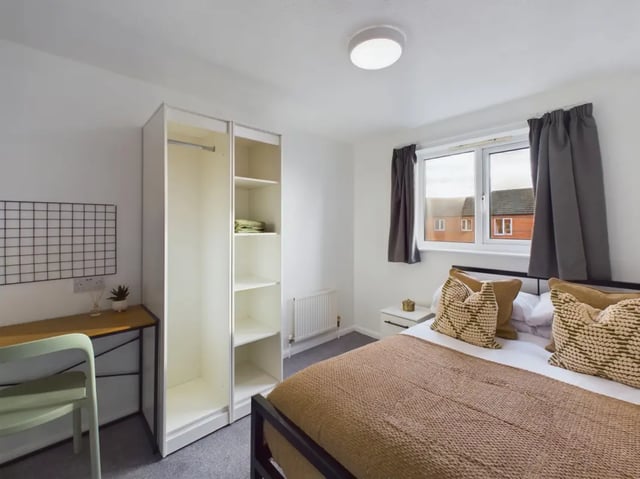 Bed wardrobe desk chair cushions window Bedroom at 6 Bedroom House at 15, Sage Road in Leicester Student Accommodation