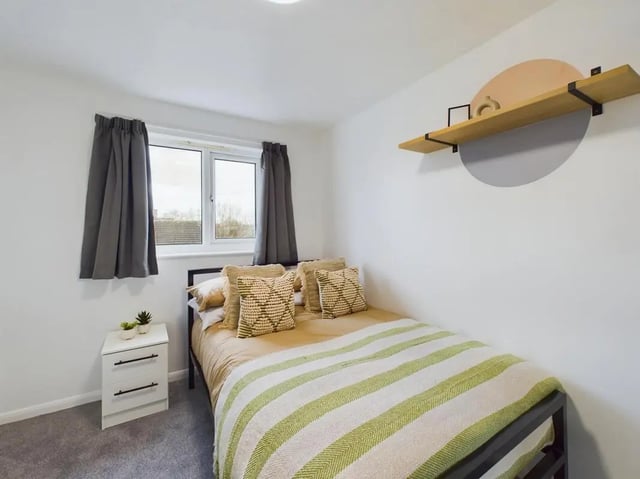 Bed with patterned pillows and striped throw Bedroom at 6 Bedroom House at 5, Mint Road in Leicester Student Accommodation