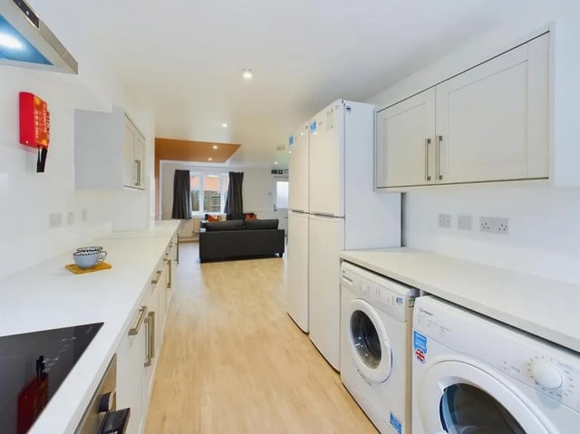 Kitchen with fridges and laundry appliances living room Kitchen at 6 Bedroom House at 9, Sage Road in Leicester Student Accommodation