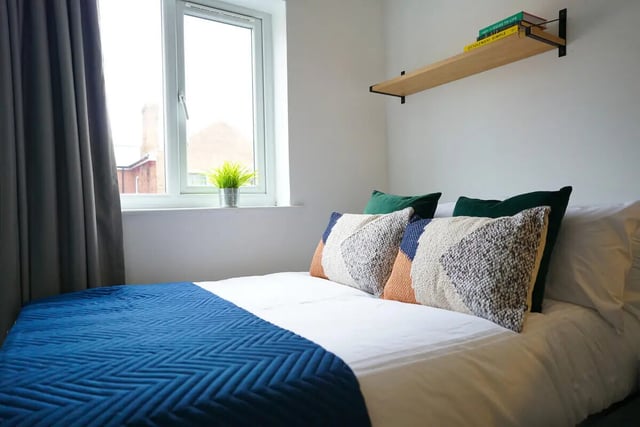 Bed with pillows and blue throw bedroom at 6 Bedroom House at 64A, Monson Street in Lincoln Student Accommodation