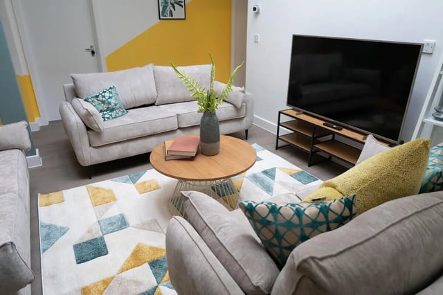 Sofa coffee table TV rug pillows living room at 12 Bedroom House at Freya House, Thesiger Street in Lincoln Student Accommodation