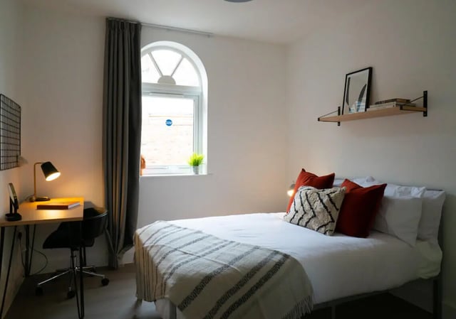 Bed desk lamp chair and pillows bedroom at 12 Bedroom House at Freya House, Thesiger Street in Lincoln Student Accommodation
