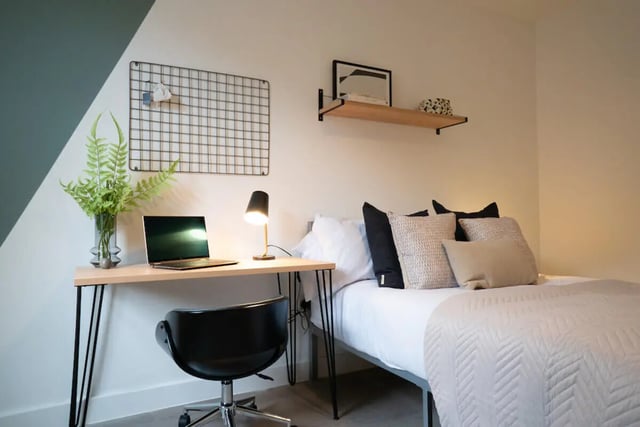 Desk with laptop bed with pillows bedroom at 6 Bedroom House at Loren House, Thesiger Street in Lincoln Student Accommodation
