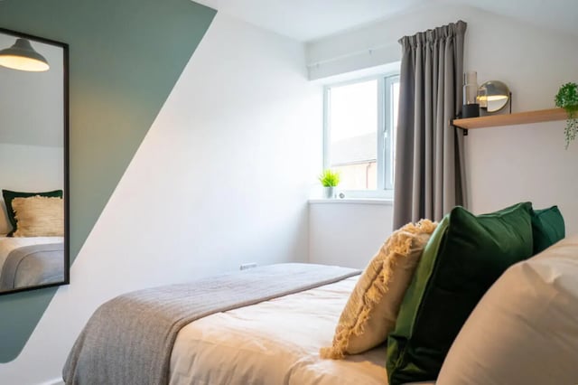 Bed with pillows mirror and window bedroom at 5 Bedroom House at 121, Tyler House, Canwick Road in Lincoln Student Accommodation