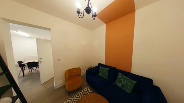 Blue sofa orange chair study area living room at 5 Bedroom House at 121, Tyler House, Canwick Road in Lincoln Student Accommodation