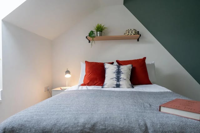 Bed with red pillows and lamp bedroom at 5 Bedroom House at 121, Tyler House, Canwick Road in Lincoln Student Accommodation