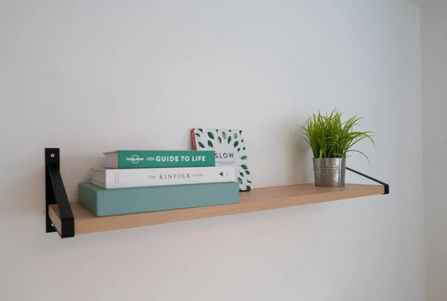 Books and plant on shelf study area at 4 Bedroom House at 119, Oliver House, Canwick Road in Lincoln Student Accommodation