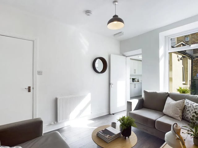 Sofa radiator door mirror kitchen living room at 5 Bedroom House at 31, Gladstone Terrace in Lancaster Student Accommodation