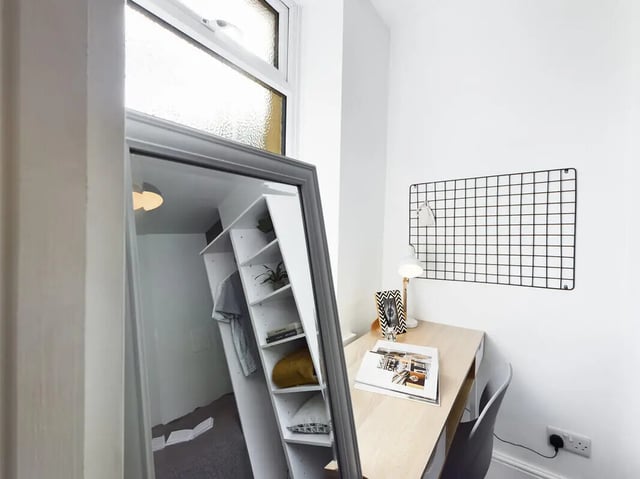 Desk shelf lamp mirror and wardrobe bedroom study area at 5 Bedroom House at 31, Gladstone Terrace in Lancaster Student Accommodation