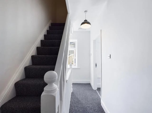 Carpeted stairs hallway white walls pendant light hallway at 5 Bedroom House at 31, Gladstone Terrace in Lancaster Student Accommodation