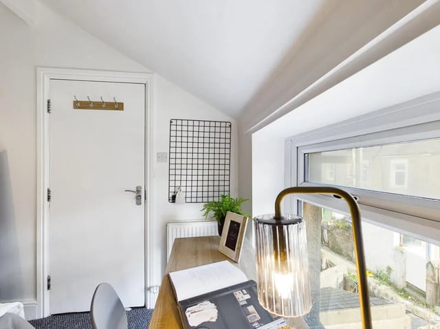 Desk lamp plant and book study area at 5 Bedroom House at 31, Gladstone Terrace in Lancaster Student Accommodation