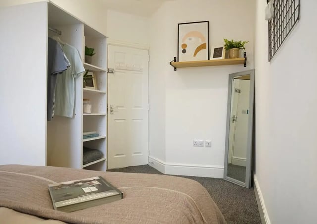 Closet shelves mirror art on wall bedroom at 6 Bedroom House at 1, Baggholme Road in Lincoln Student Accommodation