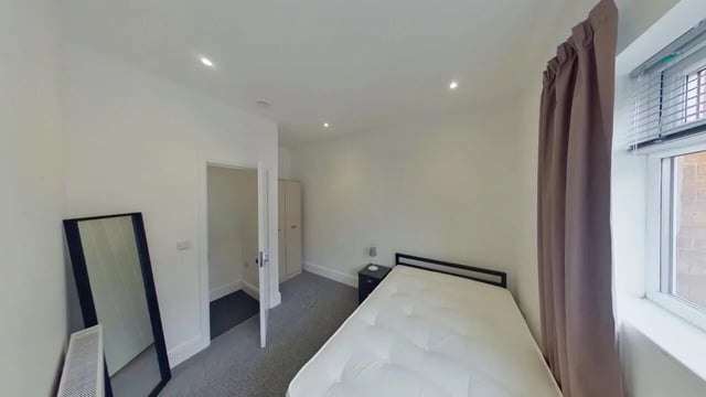 Bed mirror radiator and open wardrobe bedroom at 2 Bedroom House at 20 B, Portland Street in Lincoln Student Accommodation