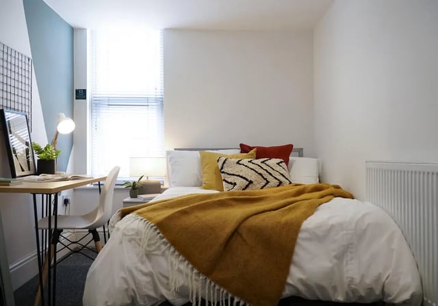 Bed desk lamp chair and plant bedroom at 6 Bedroom House at 3, Baggholme Road in Lincoln Student Accommodation